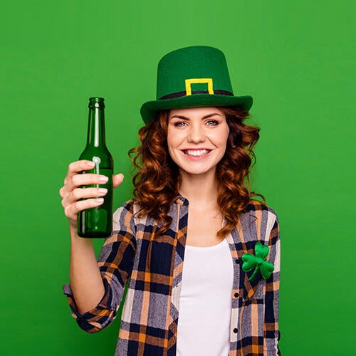 Woman in green hat holding a beer
