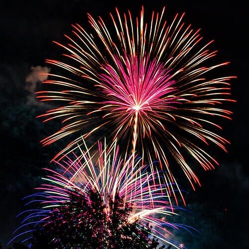 Fireworks exploding in the night sky.