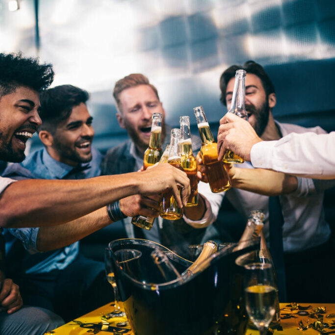 Group of young men toasting at a nightclub for a bachelor party in las vegas