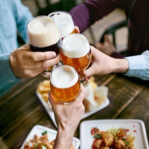 Four friends enjoying beer together at Miracle Mile Shops